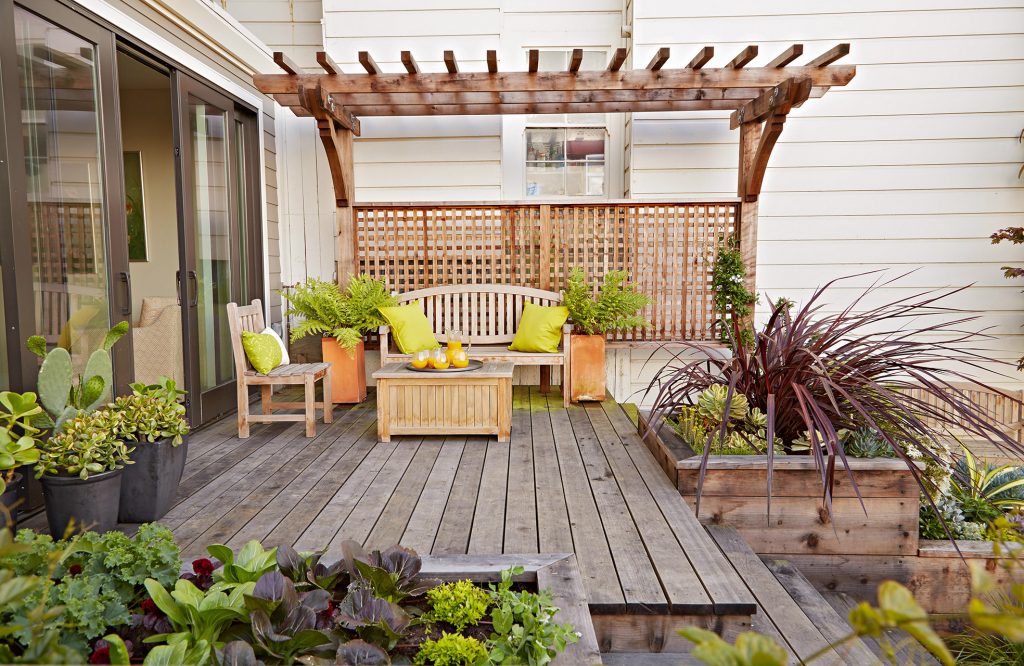 timber patio with pergola and plants around it