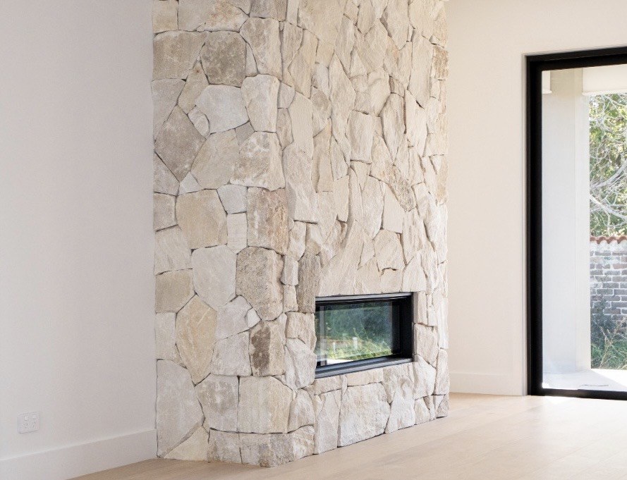 Light natural stone clad fireplace - Sunshine Coast