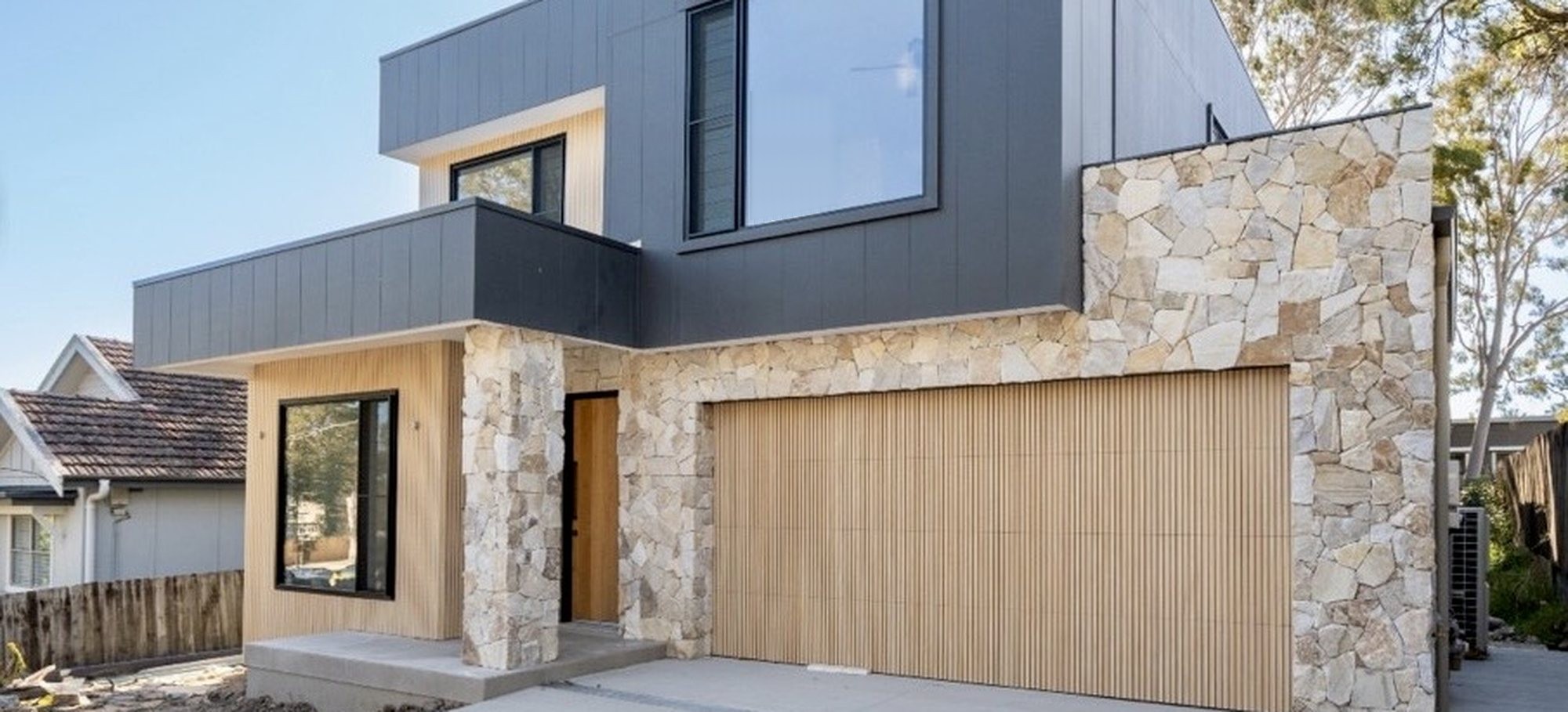 Natural stone cladding on a modern grey facade - Sunshine Coast