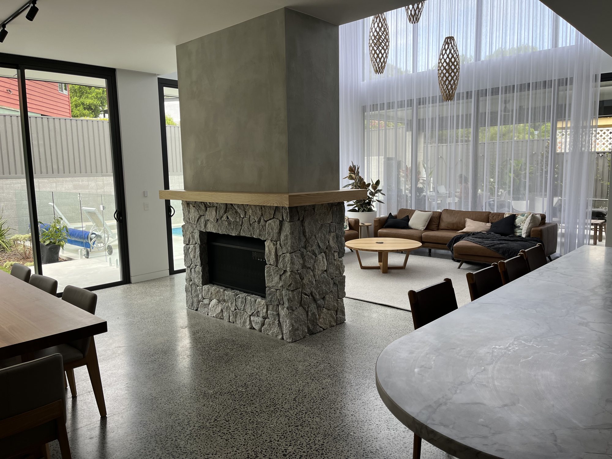 Natural stone clad double-sided fireplace in open plan living – Stone Cladding Sunshine Coast Natural stone clad double-sided fireplace in open plan living - Stone Cladding Sunshine Coast