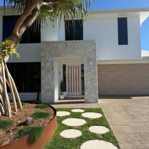 Natural stone clad front entry on coastal home - Stone Cladding Sunshine Coast
